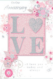 This image shows an anniversary card that gently celebrates a long, shared journey, much like couples strolling through Charlton's quiet streets in the evening. The main feature is the word LOVE, spelled out in softly raised glittered letters, each stroke lightly outlined in silver so they twinkle without overpowering the rest of the design. The O is replaced by a shimmering heart, textured in silver glitter to create a focal point that draws the eye and invites touch. Around this centerpiece, delicate blossoms in shades of blush, mauve, and soft pink open across the card as if painted in watercolour, their edges softly fading into the background. Fine, sweeping lines suggest stems and vines, weaving between the flowers in fluid, swirling motions that recall the natural grace of an English spring garden, not unlike the greenery around Maryon Park. Tiny flourishes-falling petals, spiralling curls, and unobtrusive butterfly shapes-add a sense of movement and lightness, making the overall composition feel gently animated. The backdrop is a soothing blend of pastel pinks and silvery greys, offering a calm, romantic setting for the floral artwork and glittered letters. At the top and lower sections, the words On Our Anniversary and I love you today and always appear in an understated script, elegant yet easy to read, echoing the softness of the illustration. Together, these elements create a keepsake that feels personal and heartfelt, ideal to accompany anniversary flowers delivered around Charlton's homes and gardens, capturing intimacy, devotion, and quiet celebration in one graceful card.